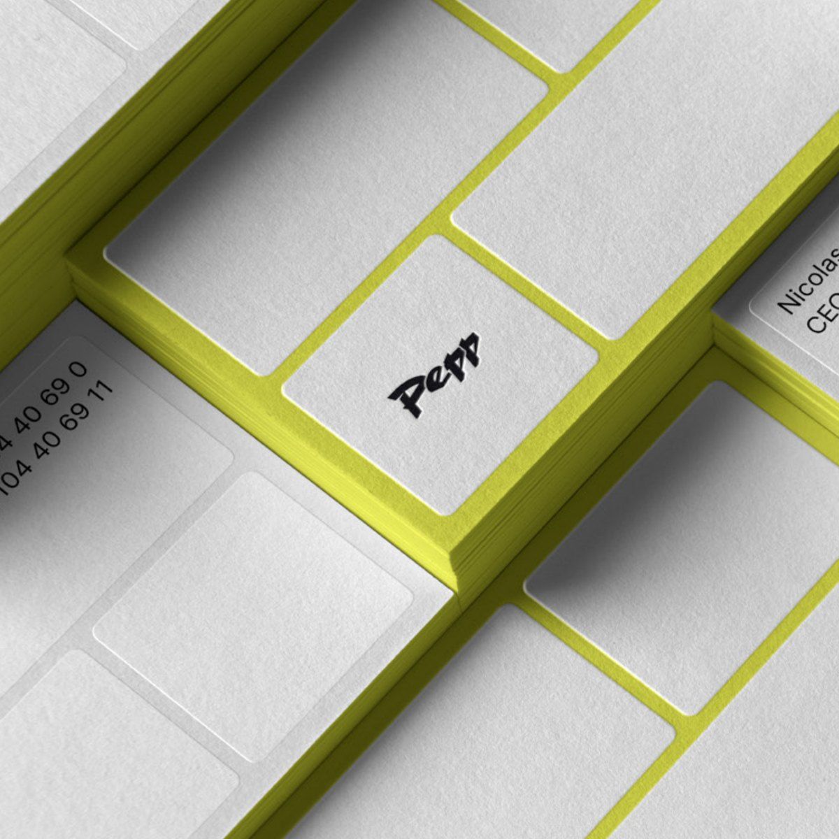 Stacked Pepp business cards with lime edges and the logo on the back