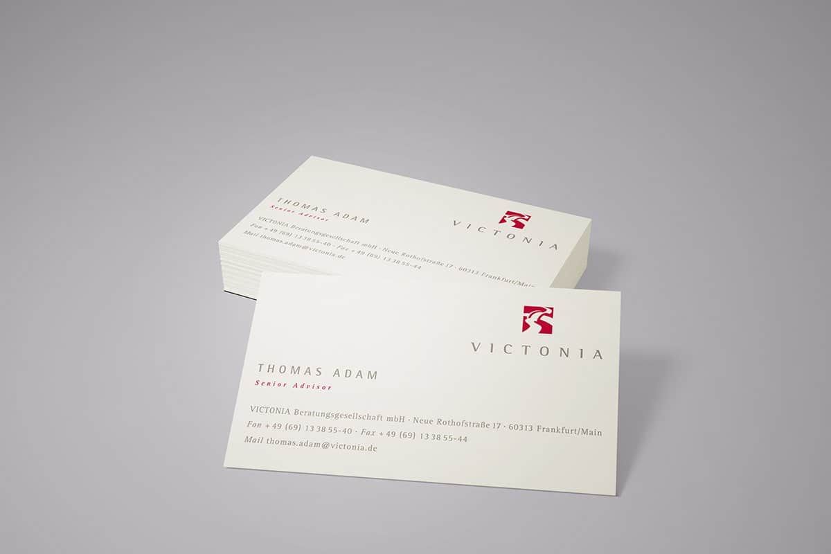 Victonia business cards with the red bridge mark and the wordmark in widely spaced capitals